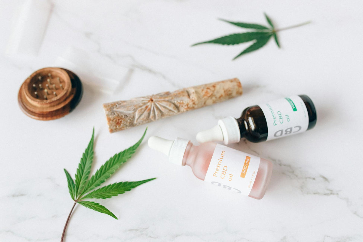 Flacons d'huile CBD avec feuilles de chanvre, illustrant les différents spectres d'extraction